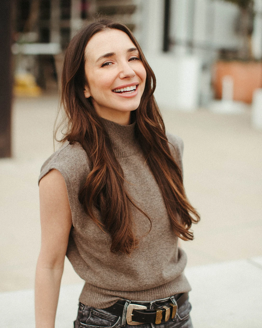 Photo of Blaine, dating coach for men, in a tan cut-off sweater, smiling